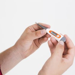 hands-holding-electrical-thermometer